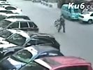 Bystander throws bicycle to thieves on scooter. 